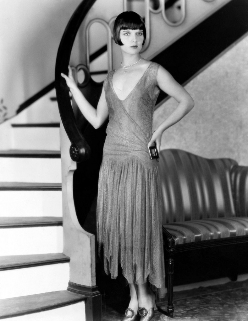 c. 1925: Louise Brooks standing by the stairway.