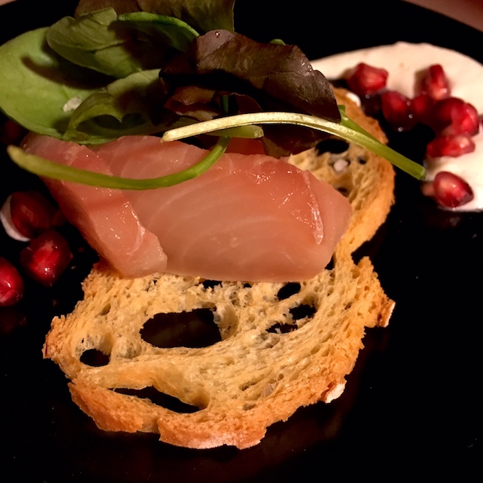 Dettaglio di Sashimi di Ricciola con Panna acida e Melograno